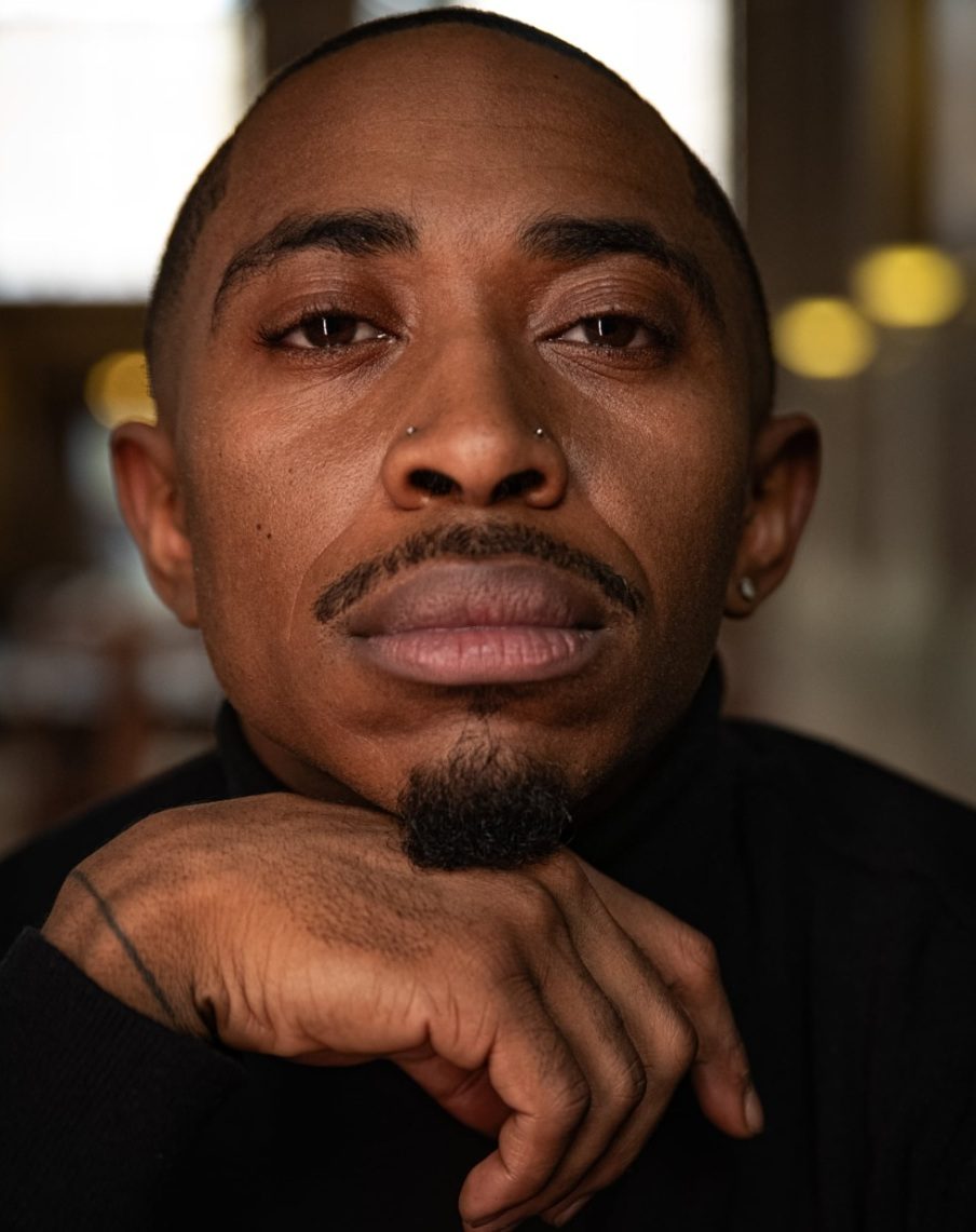 Ardimus Caldwell Jr., founder of Whois, in a black turtleneck with his chin resting on his hand