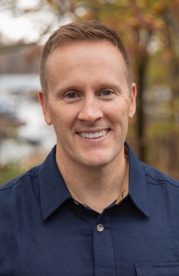 Chris Conner, president of Franchise Marketing Systems, in a navy shirt outdoors in autumn