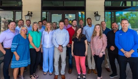 The Franchise Marketing Systems team of franchise consultants gathered outside an Atlanta office