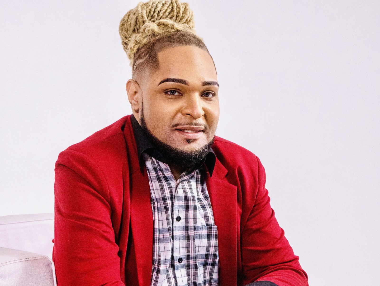 Dr. Jesse Sanders, founder of Redefined Behavioral Health & Wellness, in a red blazer