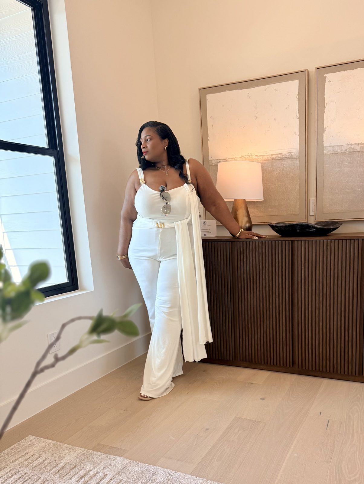 Ebony Vick standing in her office in front of a framed Empower Execute Elevate sign