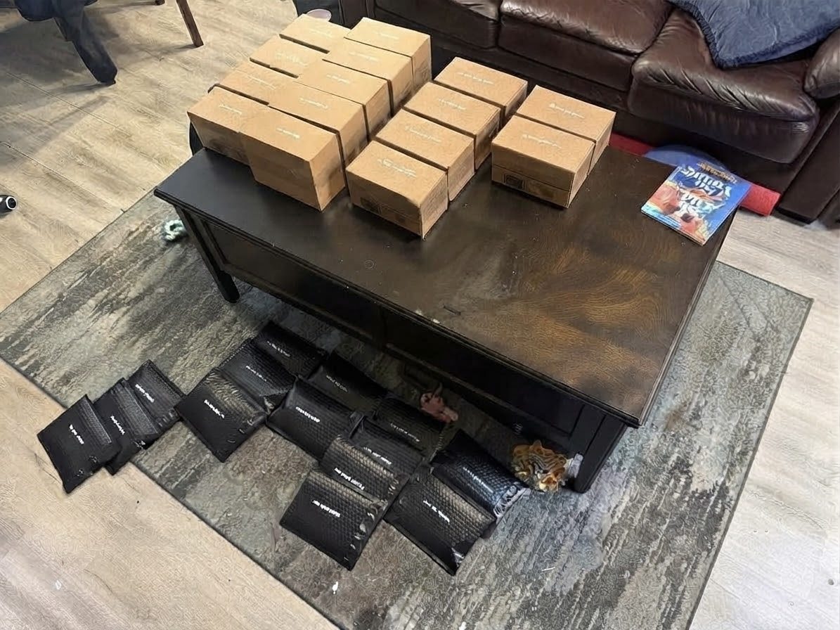 Boxed and bagged Incendiary Concepts orders laid out on a coffee table