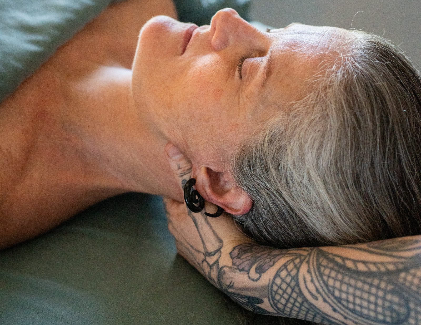 A client relaxing during a massage session at Inner Roots Wellness