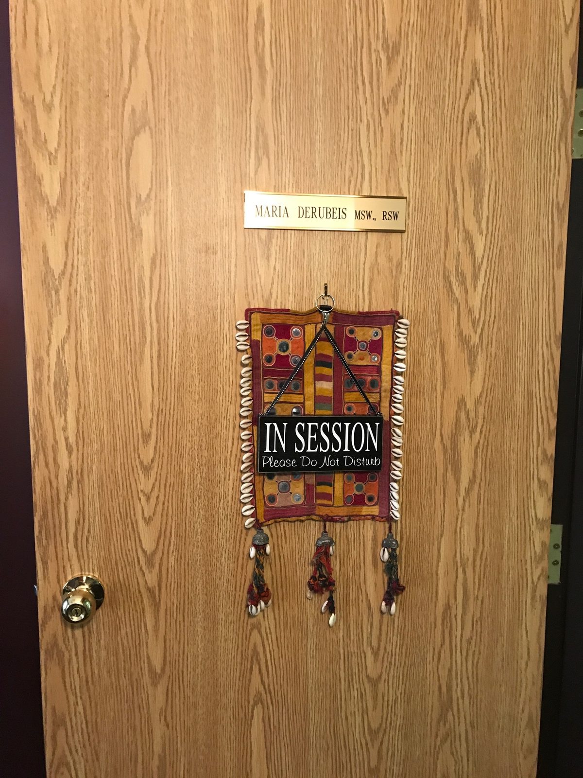 The office door of Maria DeRubeis, MSW, RSW, with an In Session sign