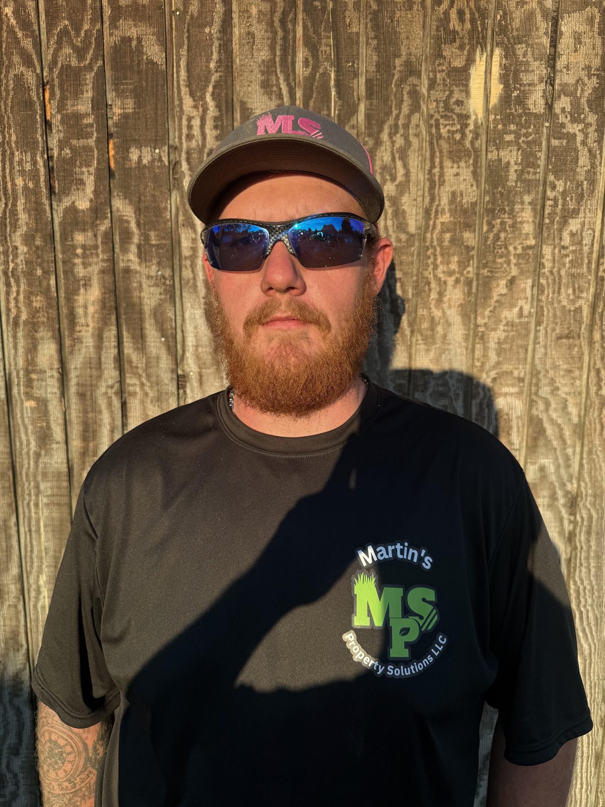 Michael Martin, founder of Martin's Property Solutions, in a black MPS shirt, cap and sunglasses