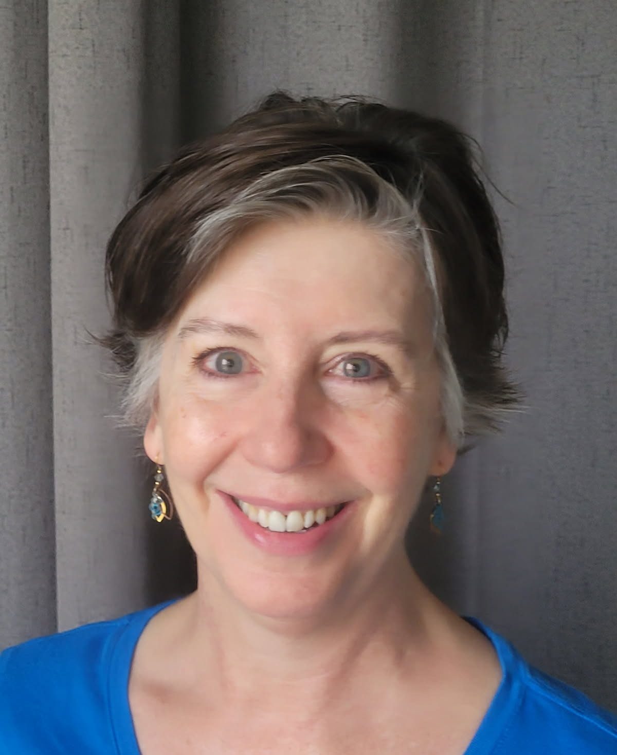Rachel Tobler, licensed massage therapist and founder of Copper Mountain Manual Therapy in Herriman, Utah, smiling in a blue top