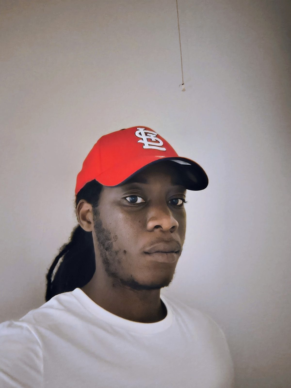 Robert Heard, founder of Sevens Magazine, in a red St. Louis Cardinals cap and a white T-shirt