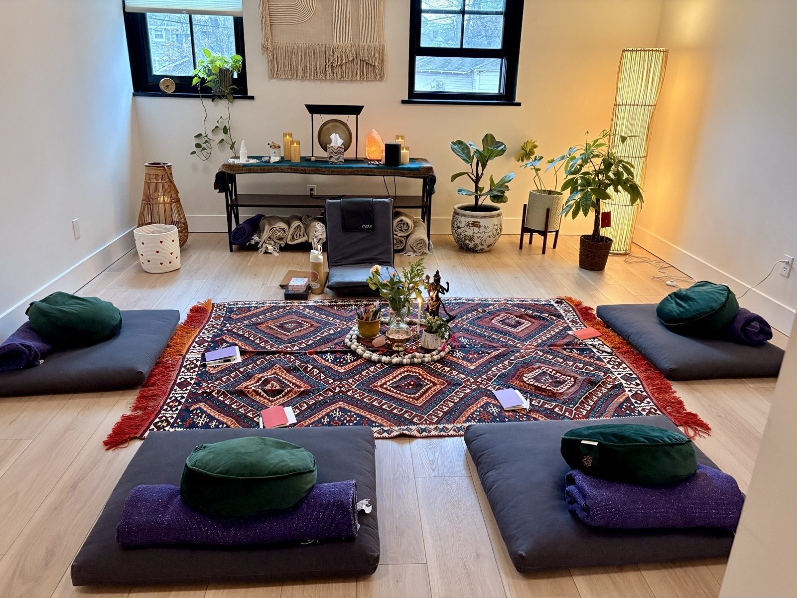 The meditation room at the Mind Body Therapy Collective in Montclair, with floor cushions arranged around a patterned rug