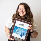 Bernice Isley, founder of Mess Of A Dreamer Photography, smiling as she holds her Best of North Carolina 2026 award plaque