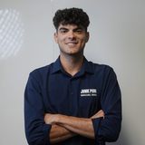 Logan Sullivan, co-founder of Junk Punks, in a navy Junk Punks Removal Service shirt