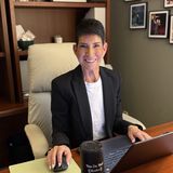 Sari Cicurel, founder of Sari M. Cicurel Public Relations, at her desk with a laptop in a black blazer